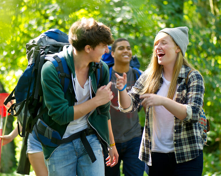 A group of friends hiking and laughing.